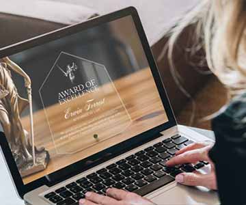 Woman looking at wording examples of appreciation plaques on her laptop.