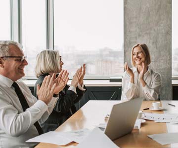 Smiling employees applauded with joy.