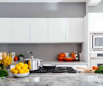 A kitchen with cooking utensils and ingredients for a meal.