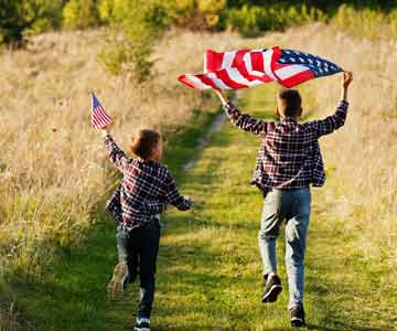 Kids running with American Flags