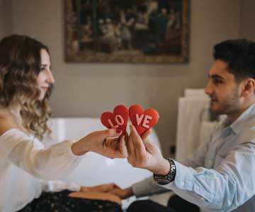 Two people exchanging cozy gifts on Valentine's Day