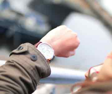 Person checking the time on their watch