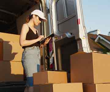 Woman checking on delivery boxes