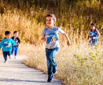 School-aged children running a race.
