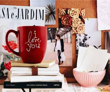 A red bistro mug next to an inspiration board.