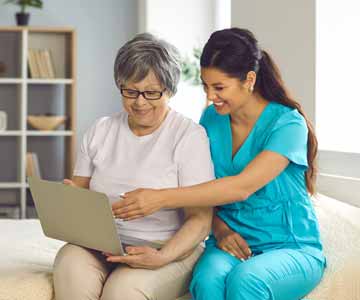 A medical personnel with a patient, sitting together inside.
