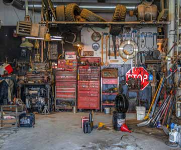 A garage that is cluttered with various objects.