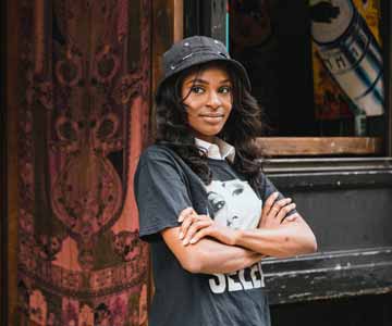 Woman standing in front of her business