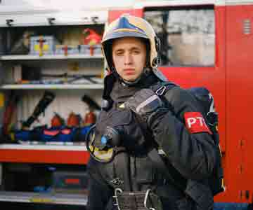 Firefighter standing next to a red fire truck