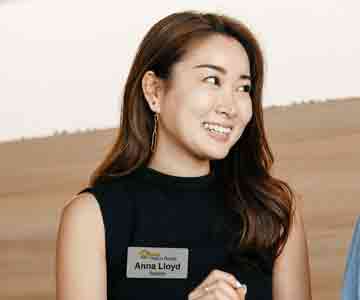Woman wearing a name tag that reads Anna Lloyd
