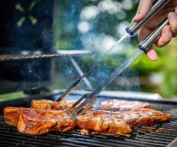 Smoking Grill With Cooking Meats On Barbecue Day