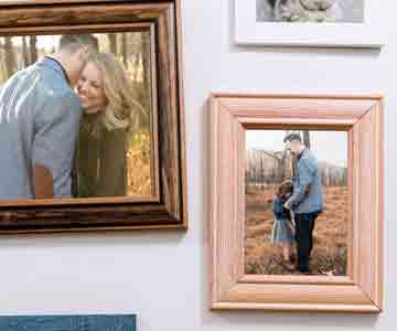 Framed couple portraits on white walls.