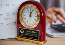 Personalized Rosewood Desk Clock Near Calendar.