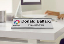 White Aluminum Desk Plate In Silver Bracket With Full Color Logo On Desk.