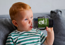 Toddler Drinking From Green Personalized Sippy Cup.
