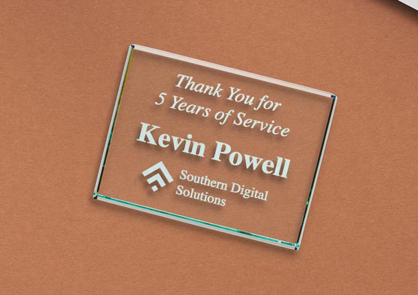 Engraved Jade Glass Paperweight On Desk Near Laptop.