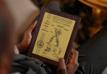 Custom Patent Plaque With Gold Plate Held By Well Dressed Man.
