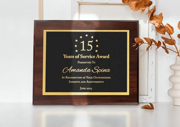 Laser Engraved Aluminum Plaque In Black Metal With Gold Engraving On Desk Near Flowers