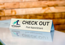 Silver Aluminum Table Tent With Full Color Logo On Receptionist Counter.