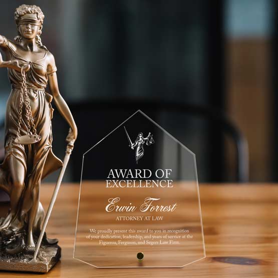 Custom Acrylic Award In Diamond Shape On Desk Next to Lady Liberty