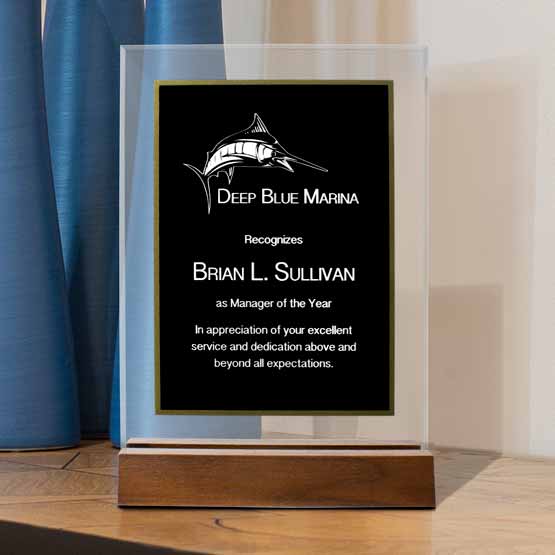 Custom Standing Black And Gold Acrylic Award For Manager Of The Year With Wooden Base On A Wood Shelf With Blue Vases
