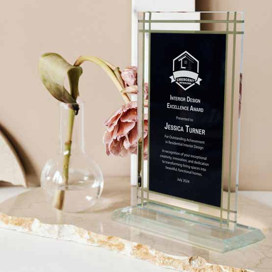 Custom Black And Gold Glass Award For Interior Design Excellence With Jade Glass Base On White Shelf Beside Flower In Vase
