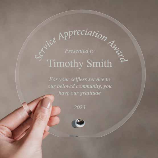 Woman Hand Holding A Custom Circle Glass Award For Service Appreciation With Name And Message And Date And Silver Pin