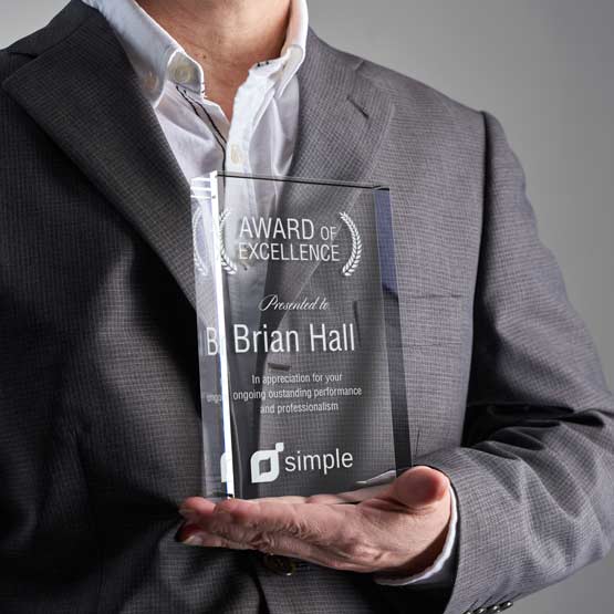 Man In Business Suit Holding Custom Same Day Glass Award With Rectangle Shape And Freestanding Design 