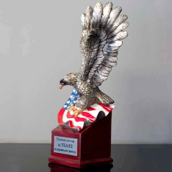 Custom Silver Resin Eagle And United States Flag Trophy For Years Of Service With Red Resin Base On Black Shelf