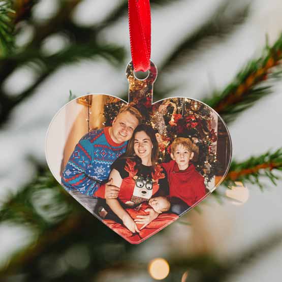 Custom Heart Shaped Acrylic Ornament With Red Ribbon And Full Color Family Photo Hanging On A Christmas Tree