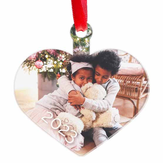 Custom Heart Shaped Acrylic Ornament With Red Ribbon And Full Color Photo Of Two Little Kids Hugging A Doll In Living Room