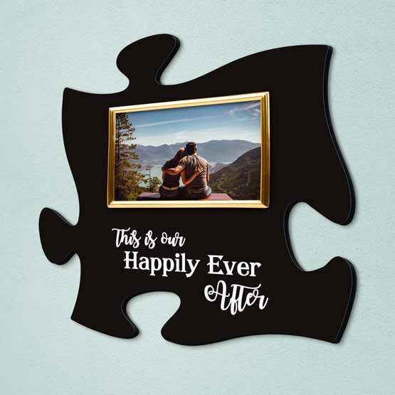 Custom Puzzle Piece Shaped Black Acrylic Sign With Happily Ever After Text And Gold Picture Frame With Couple Photo On Wall