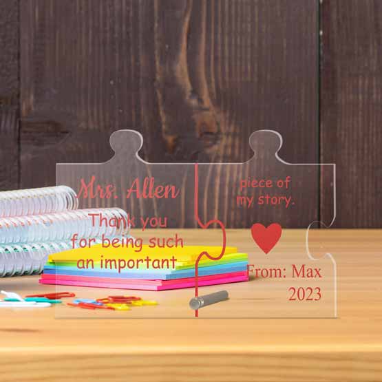 Custom Puzzle Piece Shaped Acrylic Sign With Teacher Appreciation Message On Classroom Teacher Desk With Post It Notes