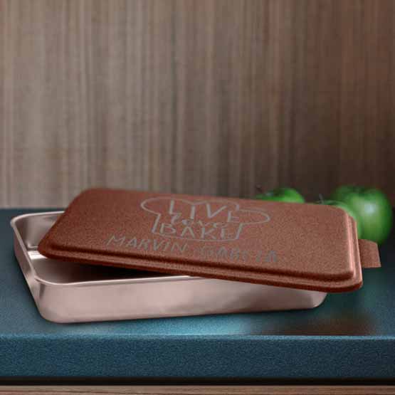 Custom Aluminum Cake Pan With Copper Lid Featuring Bread Art And Live Love Bake Text On Blue Kitchen Counter With Apples