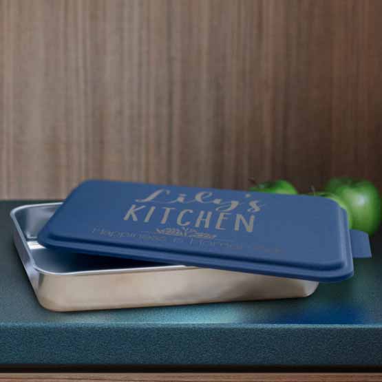 Custom Aluminum Cake Pan With Rectangle Shape And Navy Blue Lid With Lily’s Kitchen Text On Blue Kitchen Counter With Apples