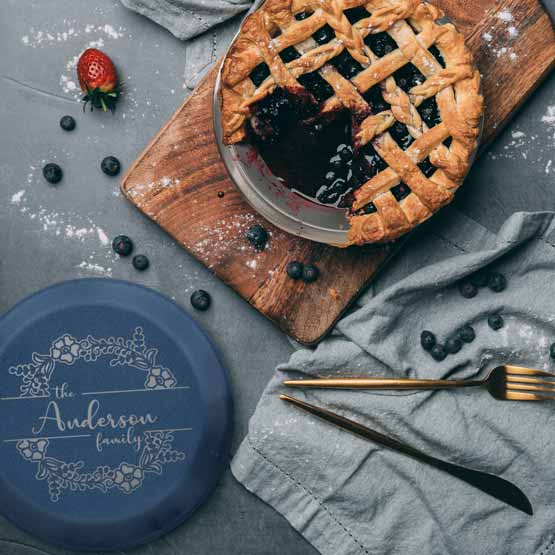 Custom Nine Inch Aluminum Pie Pan With Navy Blue Lid Featuring Flower Art And Family Name On Table With Berry Pie