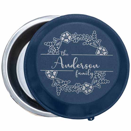 Custom Nine Inch Aluminum Pie Pan With Navy Blue Lid Featuring Flower Art And Family Name Against White Background