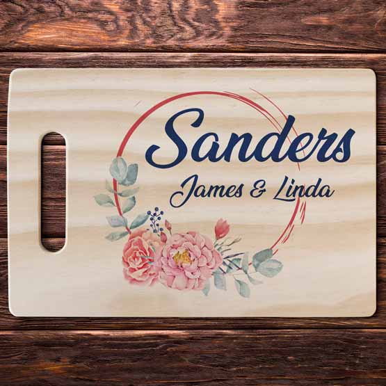 Custom Pine And Bamboo Cutting Board With Full Color Names And Flower Artwork Displayed On A Wood Table