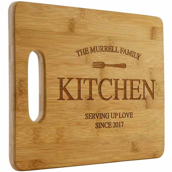 Custom Bamboo Cutting Board With Laser Engraved Fork Art And Family Name Kitchen Text And Date Against White Background