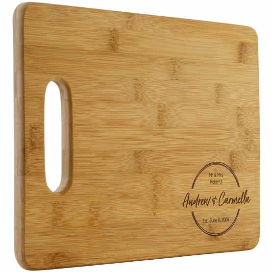 Custom Bamboo Cutting Board With Couple Names And Family Name And Established Date Against A White Background