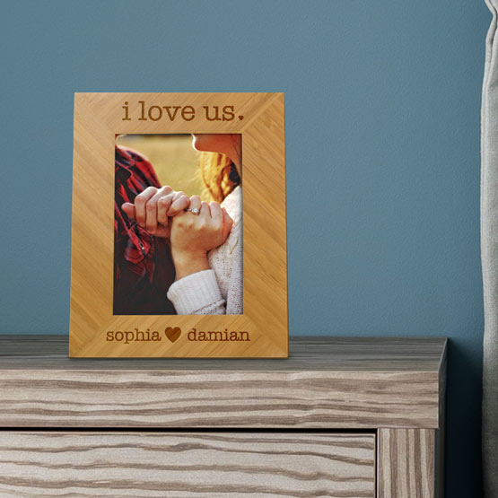 Custom Bamboo Picture Frame With Photo Of Married Couple Hands And Engraved With I Love Us Text And Names On Dresser Near Bed