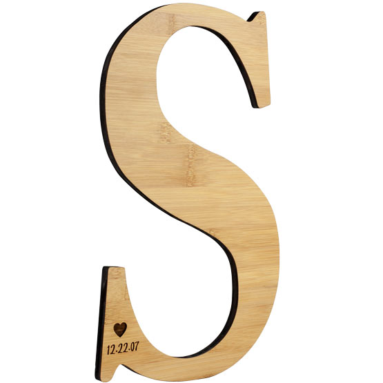 Custom Bamboo Sign With Letter S Shape And Laser Engraved With Heart Artwork And Date Against A White Background