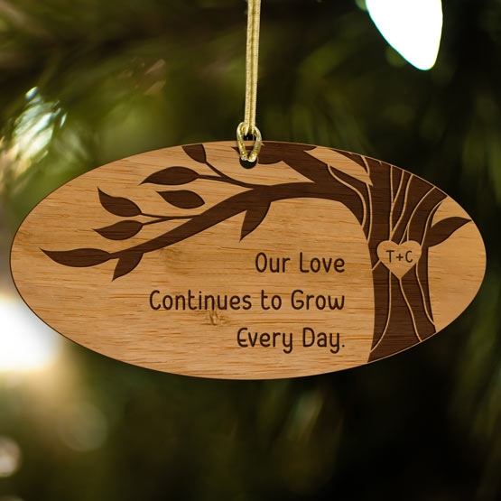 Custom Oval Bamboo Ornament Engraved With Tree Artwork And Couple Initials And Romantic Message Hanging On Christmas Tree