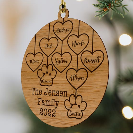 Custom Circle Bamboo Ornament Engraved With Family Names And Hearts And Paw Prints And Year Hanging On Christmas Tree