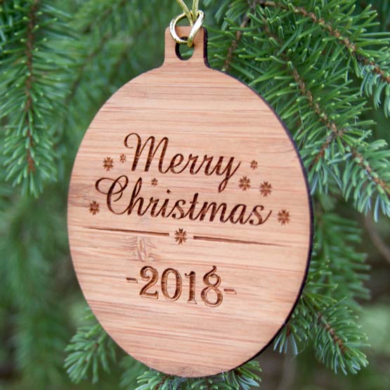 Custom Circle Shaped Bamboo Ornament Engraved With Merry Christmas Message And Date Hanging On Christmas Tree Via Gold String