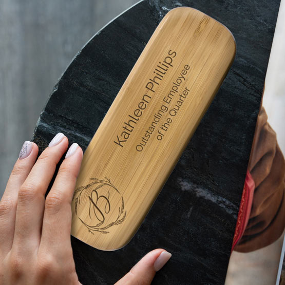 Woman Hand Holding Custom Bamboo Pen Case Laser Engraved With Logo And Name And Outstanding Employee Of The Quarter Text