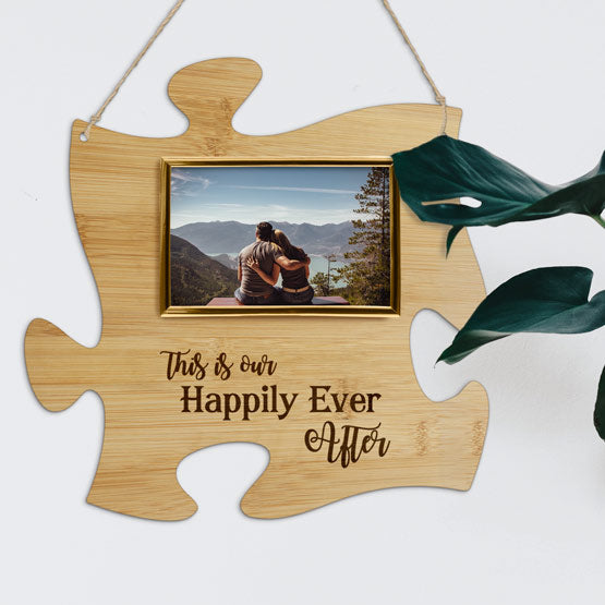Custom Puzzle Piece Bamboo Sign With Gold Picture Frame And Couple Photo And Happily Ever After Text Hanging On A Wall