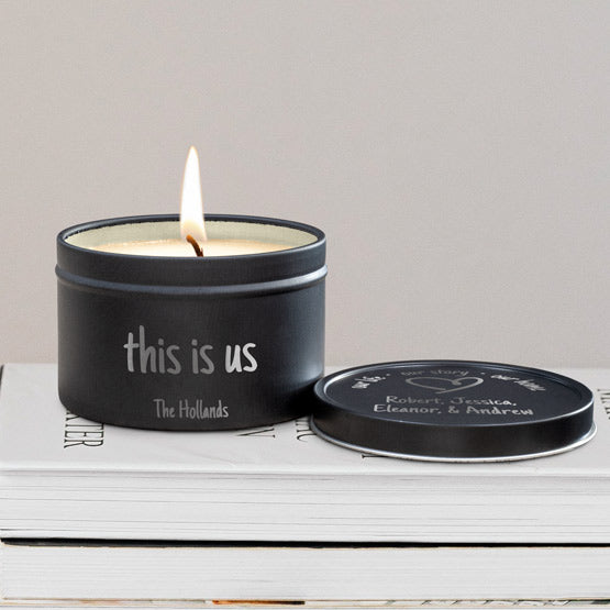 Custom Soy Candle With Black Tin Lid And Case Engraved With This Is Us And Family Names And Heart On A Stack Of Books