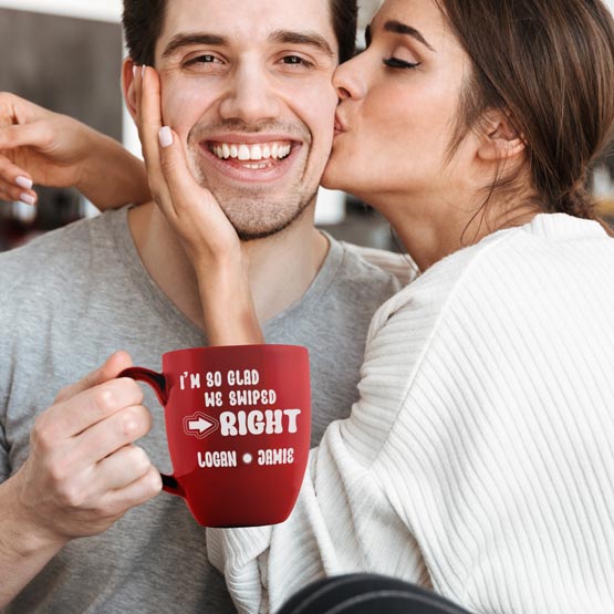 Woman Kissing Happy Man Holding Custom Red Ceramic Bistro Mug Engraved With Names And I’m So Glad We Swiped Right