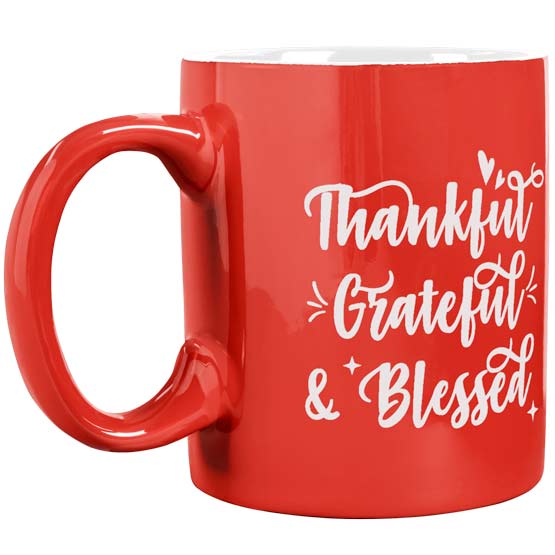 Custom Orange Coffee Mug Laser Engraved With Cursive Thankful Grateful And Blessed Text Against A White Background